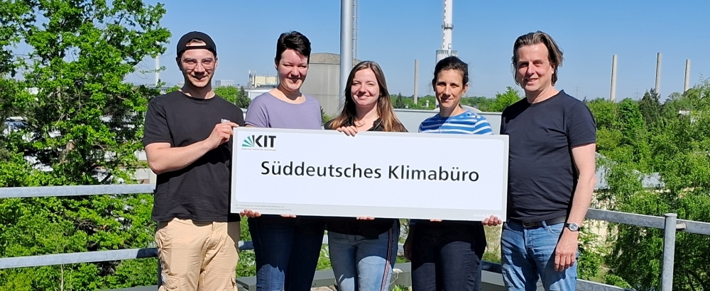 Hans Schipper Menschen halten ein Schild mit der Aufschrift "Süddeutsches Klimabüro".